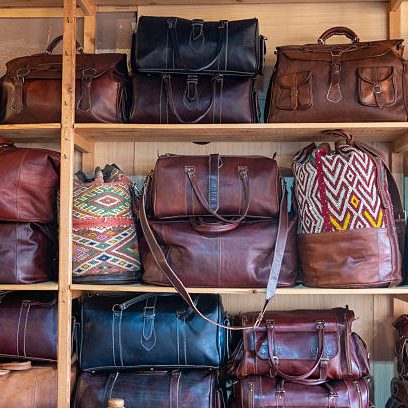 A collection of handcrafted leather bags showcased in a shop in Fez, Morocco, a city renowned for its centuries-old tanneries and exquisite leather craftsmanship, reflecting a rich cultural heritage.